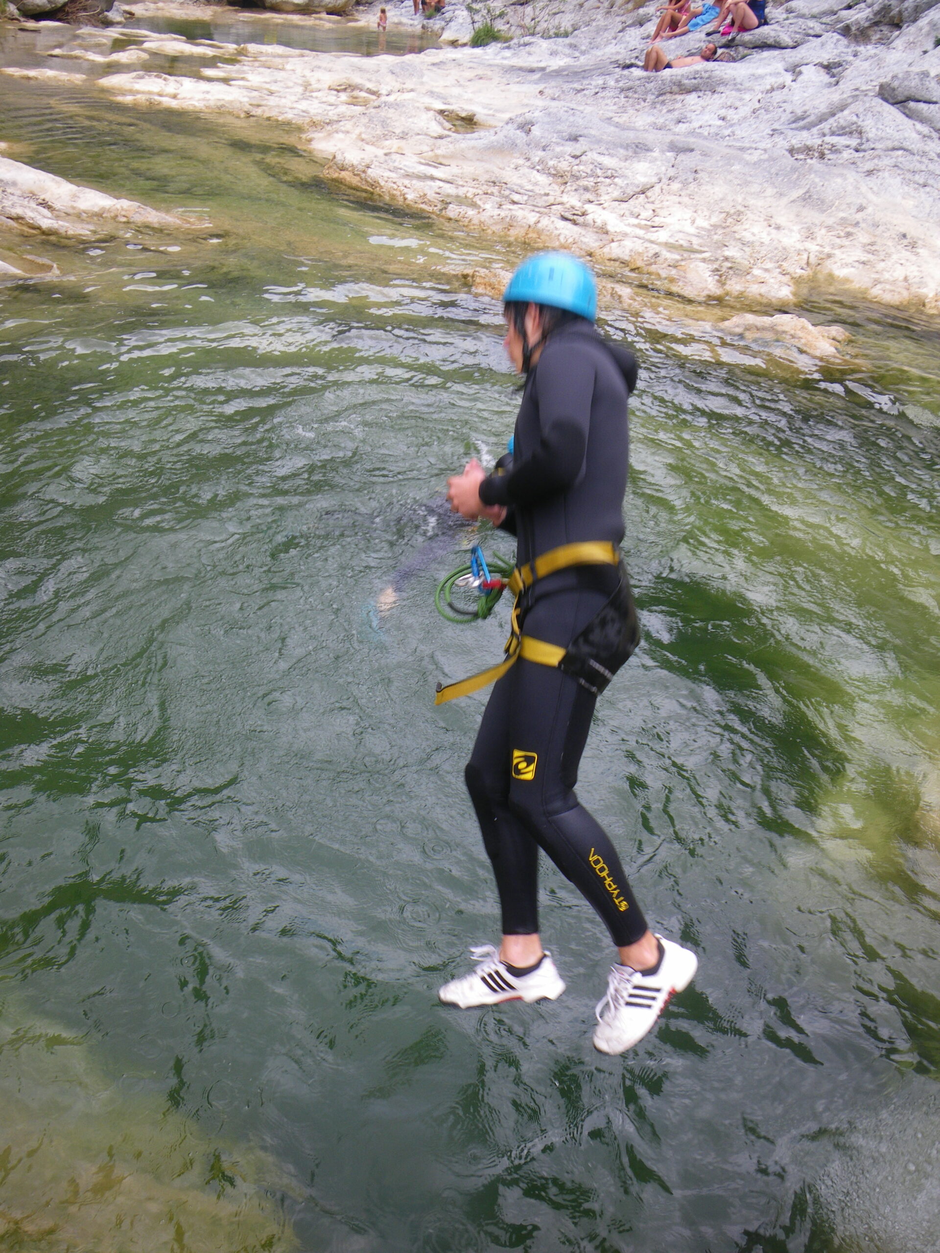 Participant jumping into a natural pool during a canyoning trip in Galamus Gorges, near Narbonne